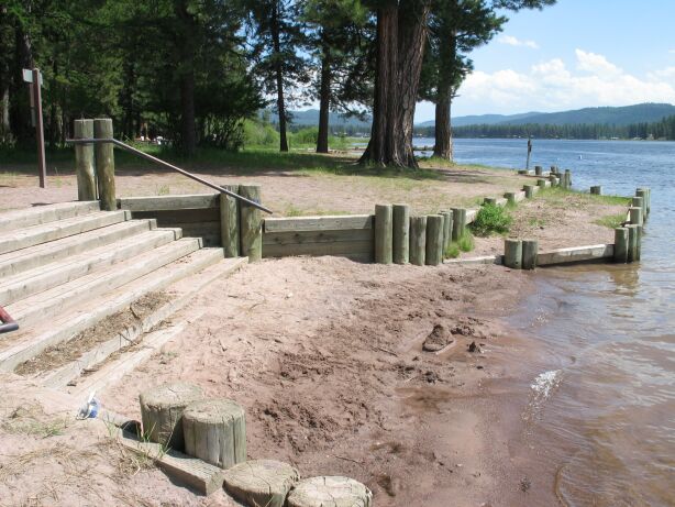 picture showing Swimming area showing steps (the only access route) leading down to the sandy beach area.