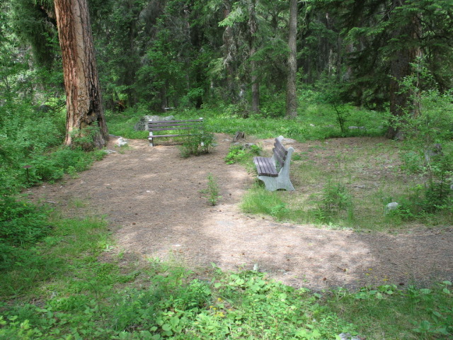 picture showing A large 10- by 15-foot paved river overlook area at the end of the paved trail.  Two benches with back supports are located along the edge of the pad.