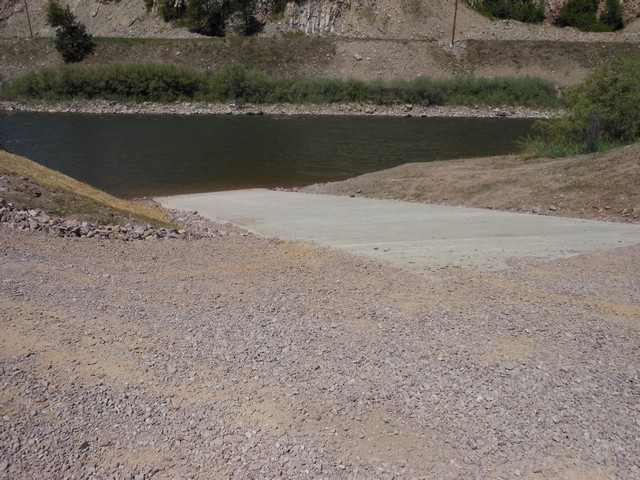 picture showing Concrete ramp with diagonal grooves for drainage and traction.  The max slope of the ramp itself is 9.5%.