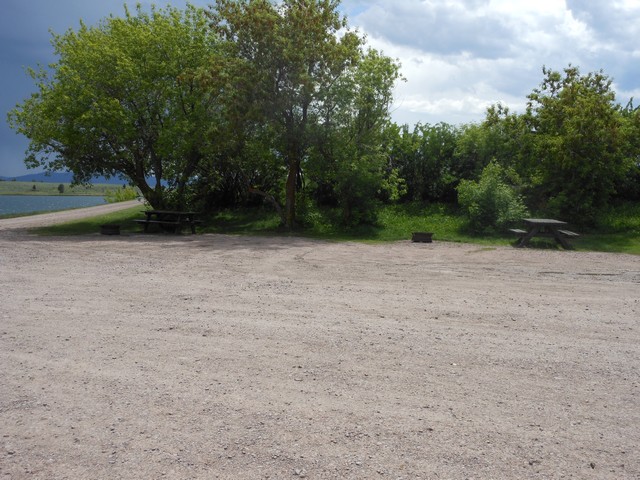 picture showing Typical campsite on lower level adjacent to lake.