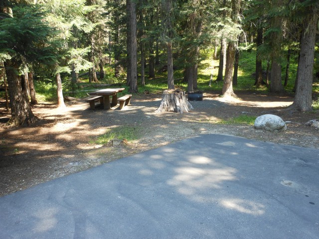 picture showing Campsite #6, with accessible table & grill.  Slopes are 5% and 1%.  Water & latrine across the road 115'.