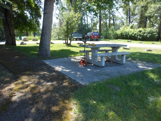 picture showing Picnic table connected by asphalt trail.