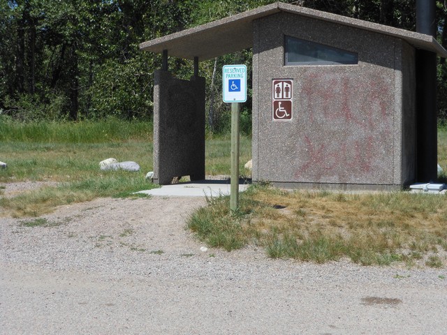 picture showing This latrine is located at the access site with the boat ramp.  The gravel path up to it is loose gravel and at a 19% slope with a 2