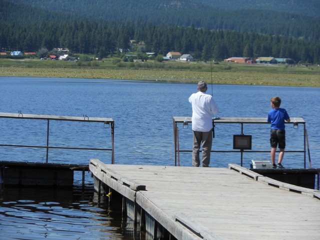 picture showing Fishermen utilizing fishing dock.
