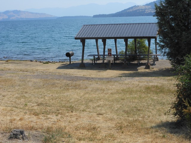 picture showing Group picnic shelter in day-use section.  There is accessible parking between the boat ramp and this picnic shelter that provides the closest access.  About 150' to the shelter will be across a natural surface that has uneven ground.