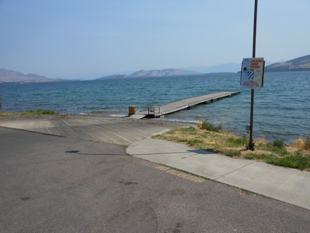 picture showing Boat ramp & dock.  From the accessible parking, the max slope to the top of the ramp is 6%, the ramp itself has a max slope of 13.3%.  The dock has a 4