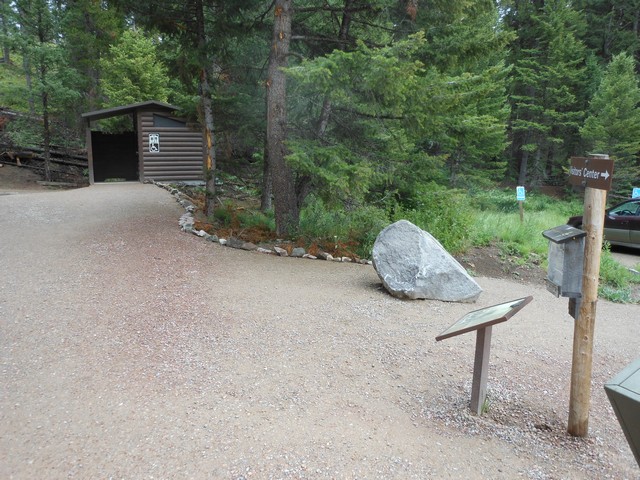 picture showing This newly installed accessible latrine is located right before you enter the town.  Drive past the main parking area above and follow the signs.  There is marked accessible parking off to the right.  The slope from the parking area is a little steep at 12% to begin but levels off to under 5% up to the latrine.