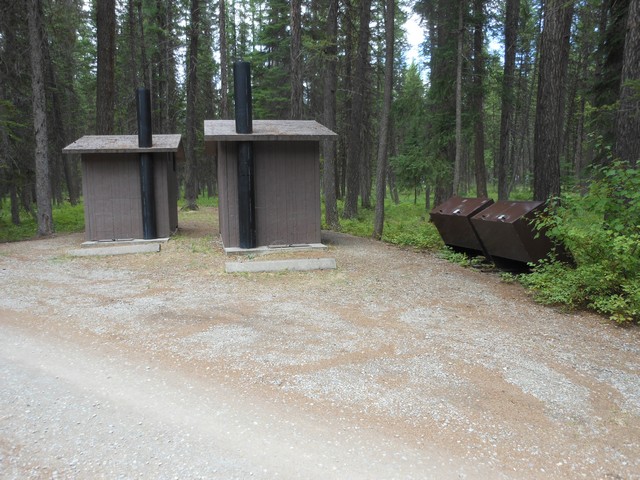 picture showing Accessible latrines and garbage dumpsters across the road from campsite #29.