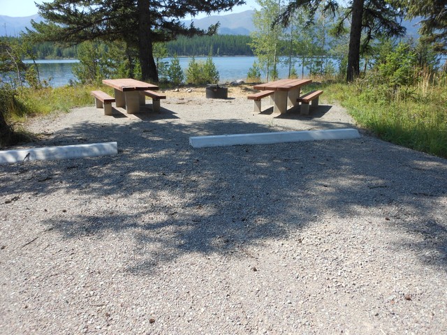 picture showing Campsite #2.  Even though it is not marked accessible, it meets the accessibility standards.  It has nice new tables & fire grill.