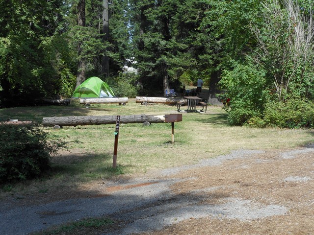 picture showing Walk-in campsites.  They have accessible tables & grills, but the routes do not meet accessible standards.  The latrine is not accessible at all.