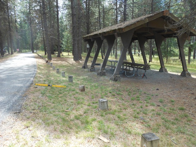 picture showing Nice old picnic shelter in loop C with two accessible tables.  However, the slope off of the roadway is 18%. This shelter is closest to the latrine at 140'.  There is another picnic shelter to the south as well and is 290' from the latrine.