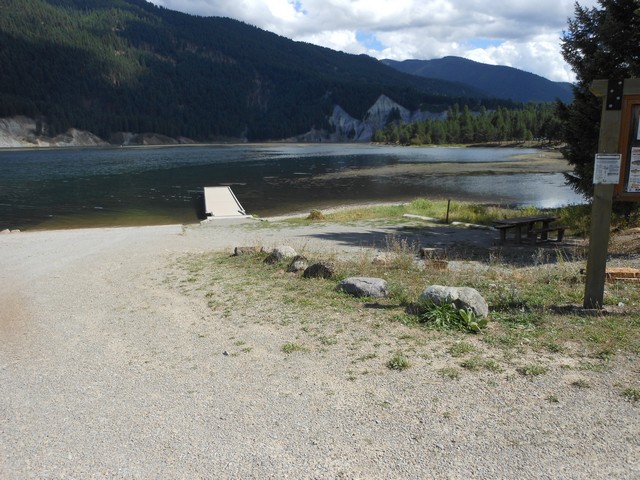 picture showing Boat launch area with ramp & dock.  Campsite #18 is off to the right of the dock.  It was the only campsite with an accessible table.