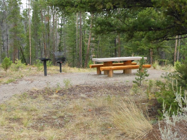 picture showing Nice table & grill.  The gravel trail surface is somewhat loose. 
