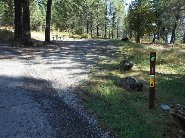 picture showing Campsite #B4, even though it is not marked accessible, has good slopes that meet accessibility standards.  The picnic table is accessible but the fire grill is not.