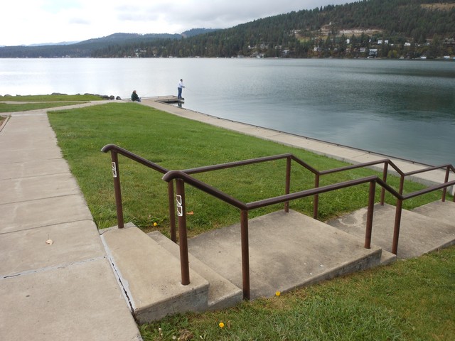 picture showing The site has a concrete walkway to access the shoreline.  Notice the fishing platform in the background.