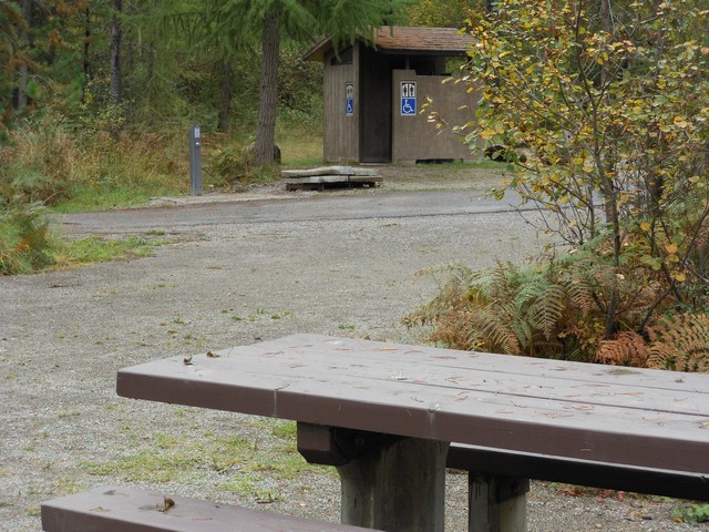 picture showing Accessible latrine and water faucet in background, across from campsite #11.