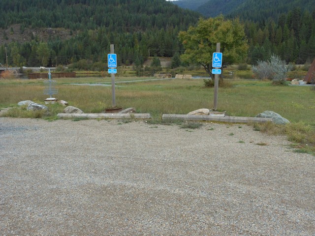picture showing Accessible parking spaces.  Notice fishing pier in the background.