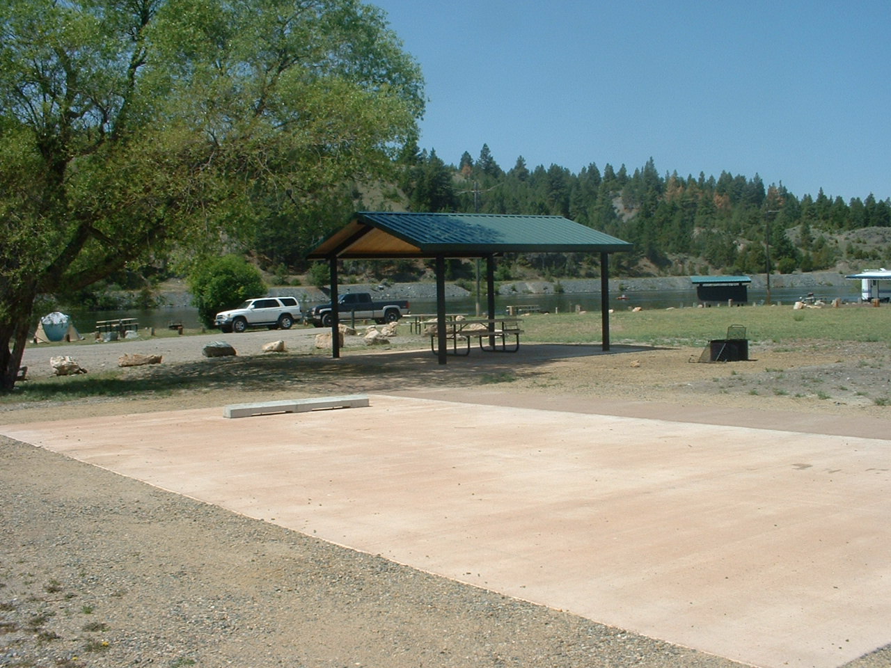 picture showing Marked accessible camping unit at Riverside Campground with shelter over the picnic table.