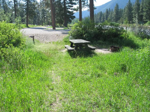 picture showing Non-accessible campsite with an unstable 17 degree slow down 3 feet from the parking pad to the campsite.  About half of the campsites have similar issues.