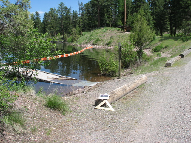 picture showing Dedicated swimming area in the southern day use section of the campground.  This picture shows the inaccessible route to the swimming area as  being very steep and unstable.  This picture also shows a dedicated swimming area floating dock that is submerged underwater on the shore side of the dock.  The dock should be dry as the spring high water level drops later in the summer.