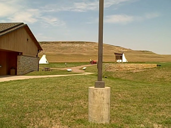 picture showing Visitor center, picnic table, and beginning of interpretive trail.